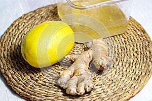 Whole lemon, honey in a jar and ginger root close-up. Drink for the treatment of flu and colds