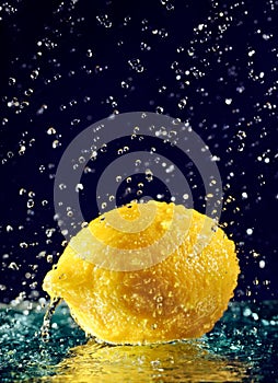 Whole lemon with stopped motion water drops