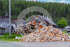 Whole lot of firewood in front of russian rural house izba