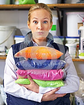 This is a whole lotta plastic. Portrait of a woman holding colorful bags of resin. photo
