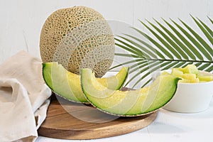 whole melon on table white background