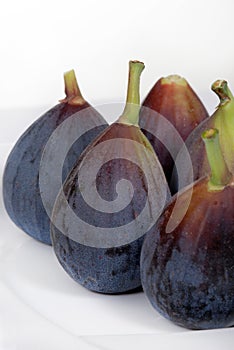 Whole, organic figs on a white plate