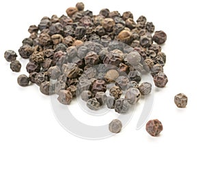 Whole peppercorn scattering on white