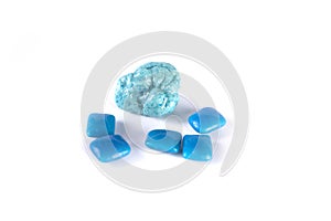 Whole pieces and chewed blue bubble gum isolated over white