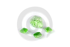 Whole pieces and chewed green bubble gum isolated over white