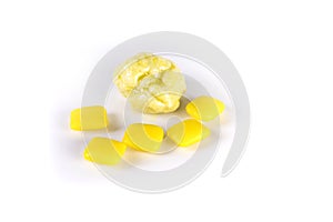 Whole pieces and chewed yellow bubble gum isolated over white