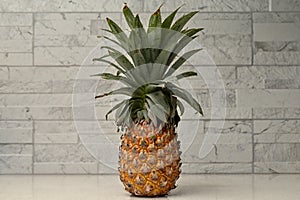 Whole Pineapple Standing Upright On Restaurant Counter, Bokeh Background