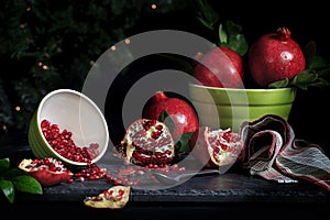 Whole Pomegranates and Seeds in Bowl