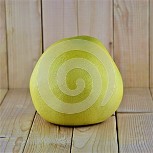 Whole pomelo on wooden background