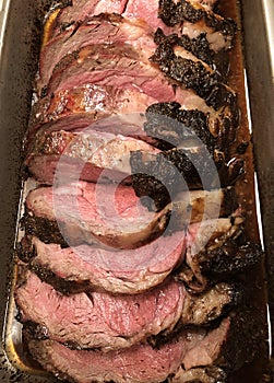 Whole prime rib roast sliced