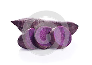Whole purple yams photographed on a white background