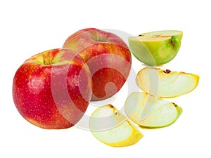 Whole red apples fruit with green, yellow slices isolated on white