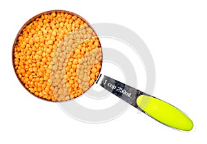 Whole red lentils in measuring cup cutout