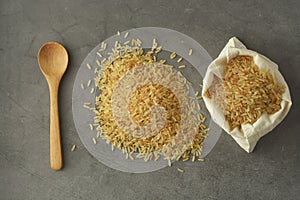 Whole rice heap. Wholegrain cereals for healthy food. Dark background