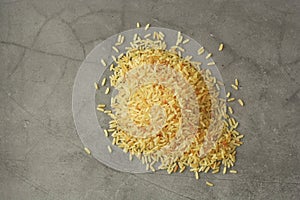 Whole rice heap. Wholegrain cereals for healthy food. Dark background