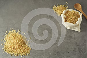 Whole rice heap. Wholegrain cereals for healthy food. Dark background. Copy space