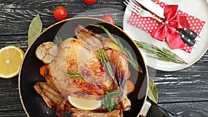 Whole roast chicken, branch holiday of a Christmas tree, candle on a wooden background slow-motion