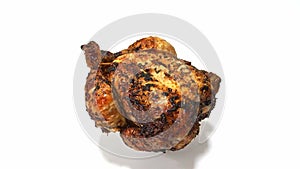 A whole roast chicken, rotating. Isolated on a white background.