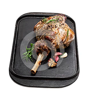 Whole roast lamb leg on grill tray isolated on white