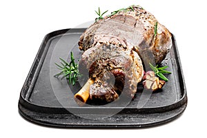 Whole roast lamb leg on grill tray isolated on white