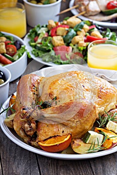 Whole roasted chicken on dinner table