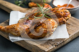 Whole roasted chicken rosemary. grilled barbecue delicious food on dining table at holiday celebrate