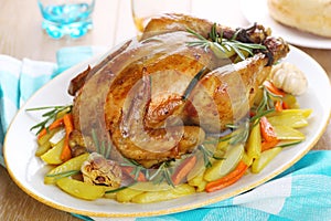 Whole roasted chicken with vegetables photo