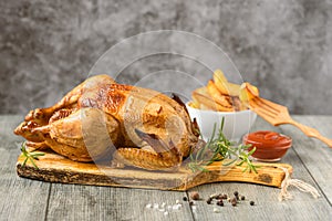 Whole roasted chicken with vegetables. Close up