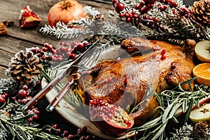 Whole roasted duck with oranges, berries and rosemary. Christmas decorations. Close up