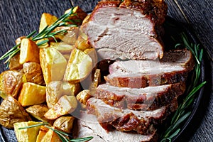 Whole roasted pork loin with baked potato wedges