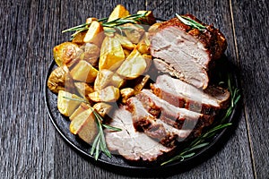 Whole roasted pork loin with baked potato wedges