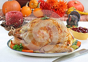 Whole roasted turkey in Thanksgiving setting.
