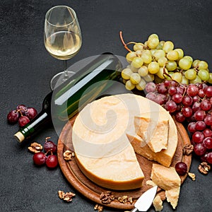 Whole round Head parmesan cheese, wine and grapes