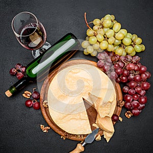 Whole round Head parmesan cheese, wine and grapes
