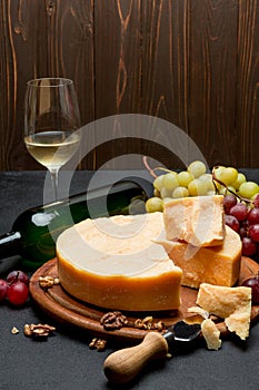 Whole round Head parmesan cheese, wine and grapes