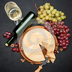 Whole round Head parmesan cheese, wine and grapes