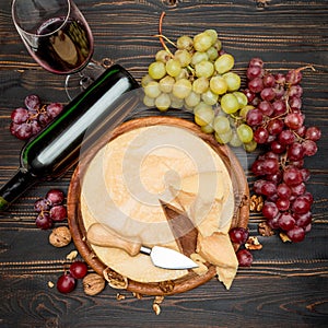 Whole round Head parmesan cheese, wine and grapes