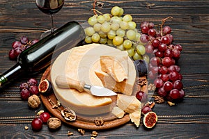 Whole round Head parmesan cheese, wine and grapes