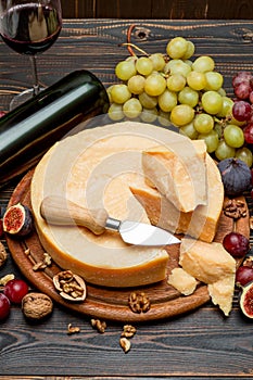 Whole round Head parmesan cheese, wine and grapes