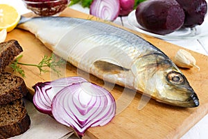 Whole salted herring with boiled beet, red onion, garlic, lemon, dill, rye bread.