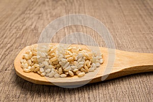 Whole Short Grain Rice Seed. Grains in wooden spoon. Rustic. photo