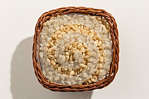 Whole Short Grain Rice Seed. Top view of grains in a basket. Close up. photo