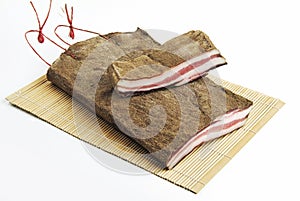 Whole and slice Bacon flavored with pepper