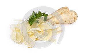 Whole and sliced fresh ripe parsnip with leaves on white background