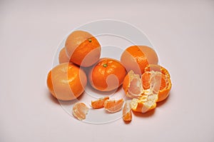 Whole and sliced mandarins on a seamless background