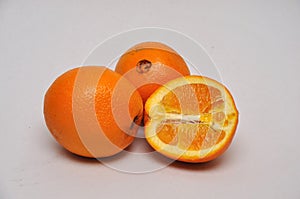 Whole and sliced navel oranges on a seamless background