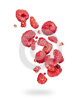 Whole and sliced raspberries in the air on a white background