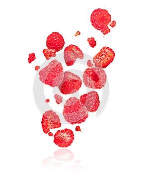 Whole and sliced raspberries in the air on a white background photo
