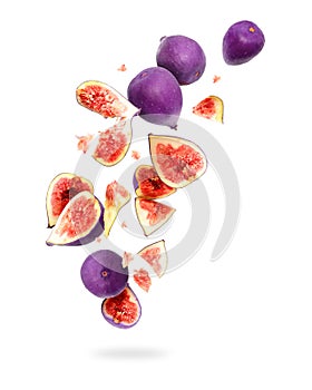 Whole and sliced ripe figs in the air, isolated on a white background