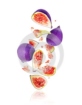 Whole and sliced ripe figs in the air isolated on a white background